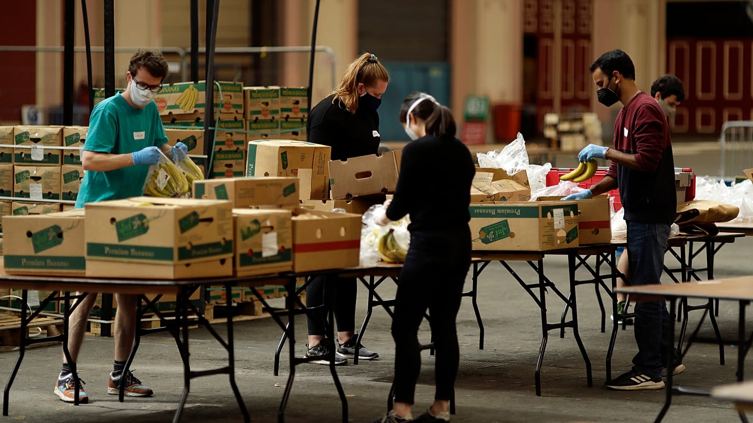 Volunteers check the quality of donated food to be put in packs delivered to residents who need it in the Haringey Council area, London, April 2020.