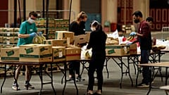 Volunteers check the quality of donated food to be put in packs delivered to residents who need it in the Haringey Council area, London, April 2020.
