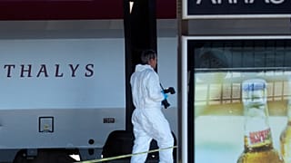 A member of the police forensics team takes part in an investigation next to a Thalys train on the platform at Arras train station, northern France, on Aug.22, 2015