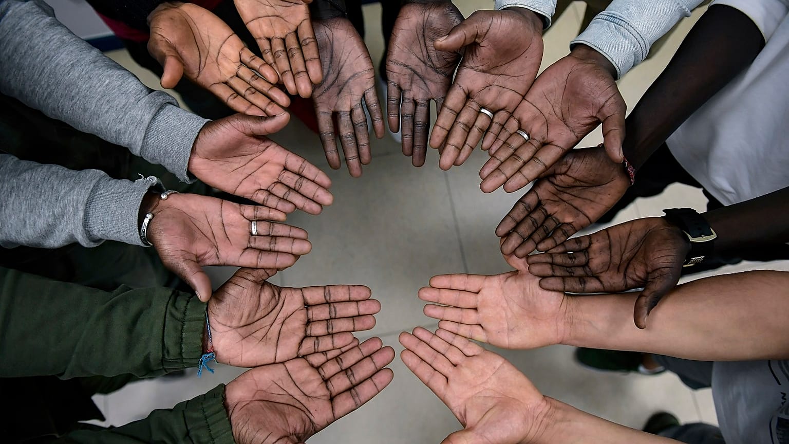 Migrant nurse Mbaye Babacar Diouf, top centre, gestures with others migrants during a workshop supporting migrants, in Bilbao, northern Spain, Wednesday, Nov. 18, 2020. 