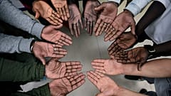 Migrant nurse Mbaye Babacar Diouf, top centre, gestures with others migrants during a workshop supporting migrants, in Bilbao, northern Spain, Wednesday, Nov. 18, 2020. 