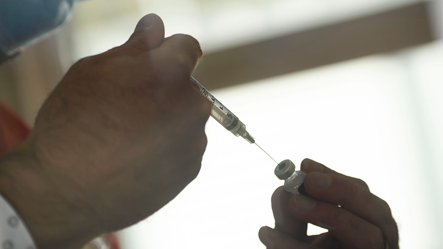 A syringe is filled from a vial of the Pfizer-BioNTech Covid-19 vaccine 