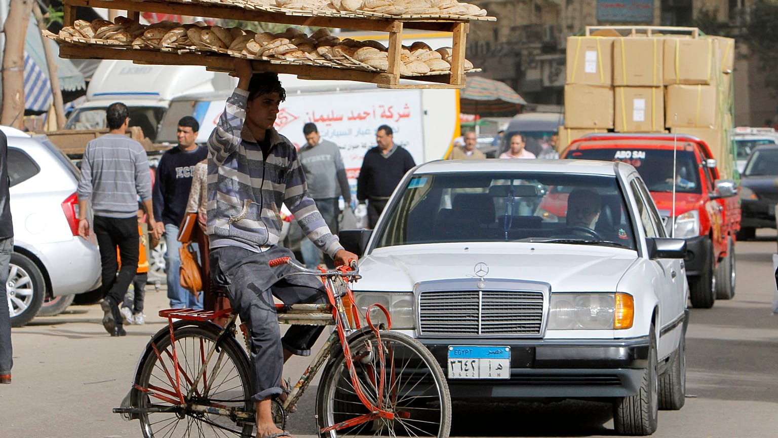 March 16, 2013 file photo, an Egyptian bread vendor rides his bicycle in downtown Cairo, Egypt
