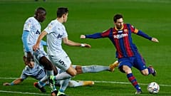 Barcelona's Lionel Messi, right, takes a shot at goal during the Spanish La Liga soccer match between Barcelona and Valencia at the Camp Nou stadium in Barcelona, Spain.