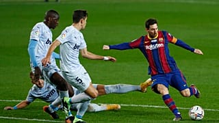 Barcelona's Lionel Messi, right, takes a shot at goal during the Spanish La Liga soccer match between Barcelona and Valencia at the Camp Nou stadium in Barcelona, Spain.