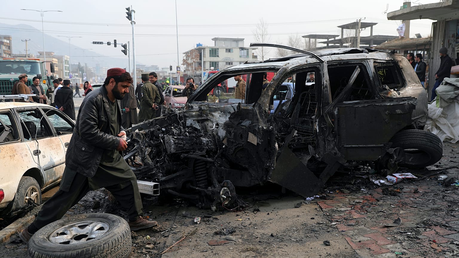 People gather near the site of a deadly bombing attack in Kabul, Afghanistan, Sunday, Dec. 20, 2020.