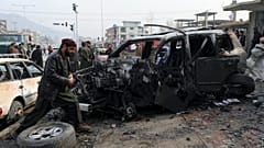 People gather near the site of a deadly bombing attack in Kabul, Afghanistan, Sunday, Dec. 20, 2020.