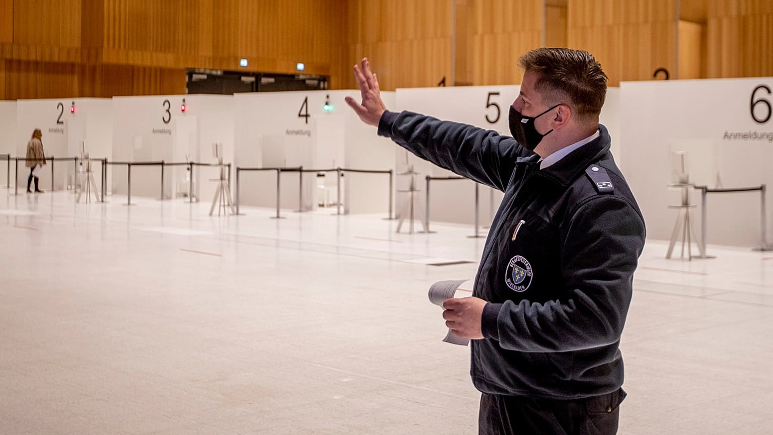 A firefighter explains the procedure of a vaccine center that was introduced to the media are seen in Wiesbaden, Germany, Monday, Dec. 7, 2020. 