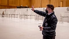 A firefighter explains the procedure of a vaccine center that was introduced to the media are seen in Wiesbaden, Germany, Monday, Dec. 7, 2020. 