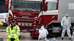 Police forensic officers attend the scene after the bodies were discovered in a truck