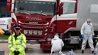 Police forensic officers attend the scene after the bodies were discovered in a truck