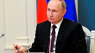 Russian President Vladimir Putin attends a meeting to mark a memorandum of cooperation on the fight against the coronavirus