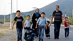 A Syrian family head to Mytilene to be counted by Greek authorities