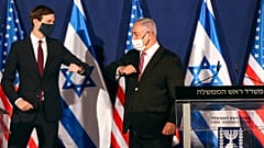 White House senior adviser Jared Kushner, left, elbow bumps Israeli Prime Minister Benjamin Netanyahu 