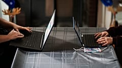 Eileen Carroll, left, works on her laptop as her daughter