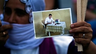 A supporter holds up a prison photograph of Selahattin Demirtaş in June 2020