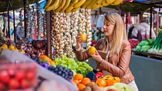 Woman shops for fresh fruit and veg in a local market