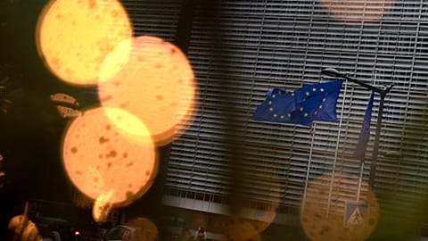 European Union flags flutter in the wind amongst Christmas decorations outside of EU headquarters in Brussels, Wednesday, Dec. 23, 2020.