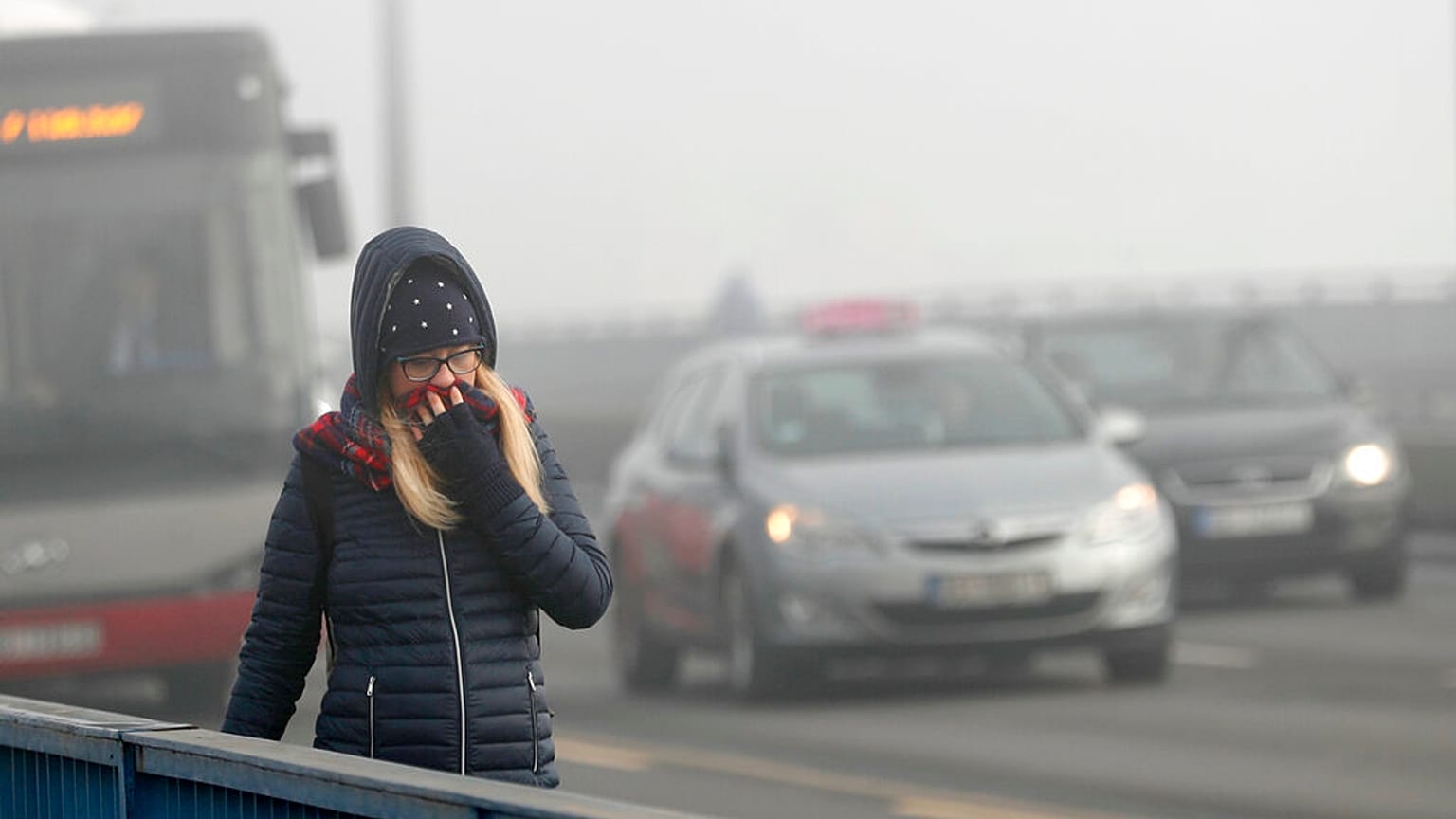 A girl walks across a bridge in Belgrade, Serbia, Wednesday, Jan. 15, 2020