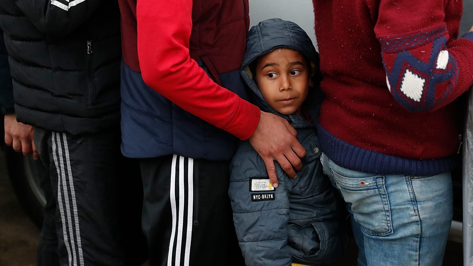 In this Tuesday, March 10, 2020 file photo, migrants wait in line for a distribution of blankets close to the Turkish-Greek border near Pazarkule, Edirne region, Turkey. 