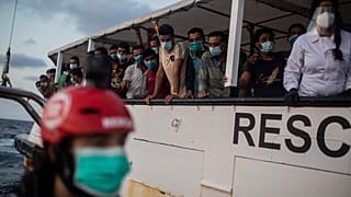FILE PHOTO- Migrants from different nationalities rest on board the Spanish NGO Open Arms vessel on Wednesday 9, 2020, after being rescued. 