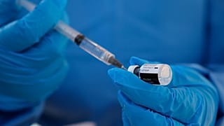 A health worker extracts a dose of the COVID-19 vaccine at the military base in Queretaro, Mexico, Thursday, Dec. 24, 2020. 