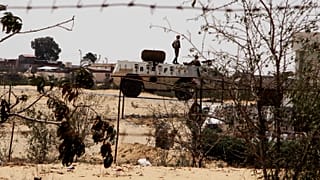 In this Monday, Aug. 6, 2012 file photo, Egyptian border guards patrol near the border with Israel in Rafah, Egypt
