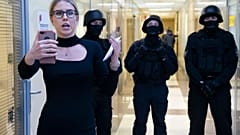 FILE - Russian opposition activist Lyubov Sobol reports live by phone as policemen stand guard at the Foundation for Fighting Corruption office in Moscow, Russia.