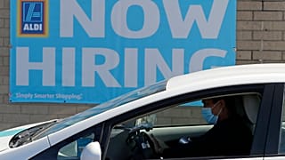 This May 8, 2020 photo shows a hiring sign at the Aldi grocery store in Morton Grove, Ill.