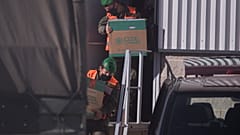 Spanish army soldiers carry the first batch of the Pfizer coronavirus vaccine in a warehouse in Cabanillas del Campo, outskirts of Guadalajara, central Spain, Dec. 26