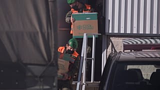 Spanish army soldiers carry the first batch of the Pfizer coronavirus vaccine in a warehouse in Cabanillas del Campo, outskirts of Guadalajara, central Spain, Dec. 26