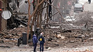 Emergency personnel work near the scene of an explosion in downtown Nashville, Tenn., Friday, Dec. 25, 2020.