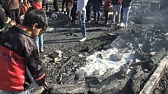 Camp residents examine aftermath of fire