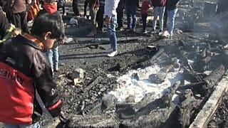Camp residents examine aftermath of fire