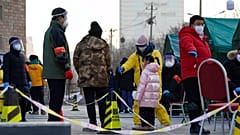 Pekingi lakosok koronavírus-tesztre várva sorakoznak.