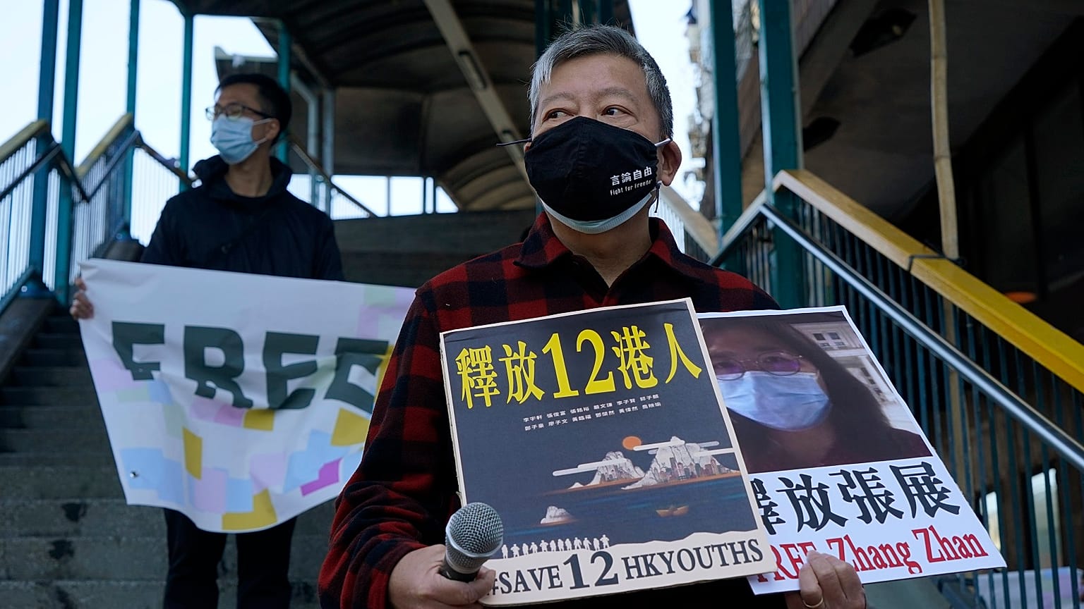 Pro-democracy activists hold placards with the picture of jailed Chinese citizen journalist Zhang Zhan in Hong Kong, Monday, Dec. 28, 2020.