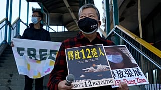 Pro-democracy activists hold placards with the picture of jailed Chinese citizen journalist Zhang Zhan in Hong Kong, Monday, Dec. 28, 2020.