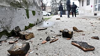 Residents in Sisak inspect damage caused by the earthquake.