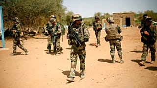 FILE-- In this photo taken Sunday Feb. 10, 2013, French soldiers secure the area where a suicide bomber exploded at the entrance of Gao, northern Mali.