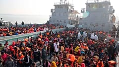 Rohingya refugees settle on to naval ships to be transported to an isolated island in the Bay of Bengal, in Chittagong, Bangladesh, Tuesday, Dec. 29, 2020.