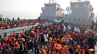 Rohingya refugees settle on to naval ships to be transported to an isolated island in the Bay of Bengal, in Chittagong, Bangladesh, Tuesday, Dec. 29, 2020.