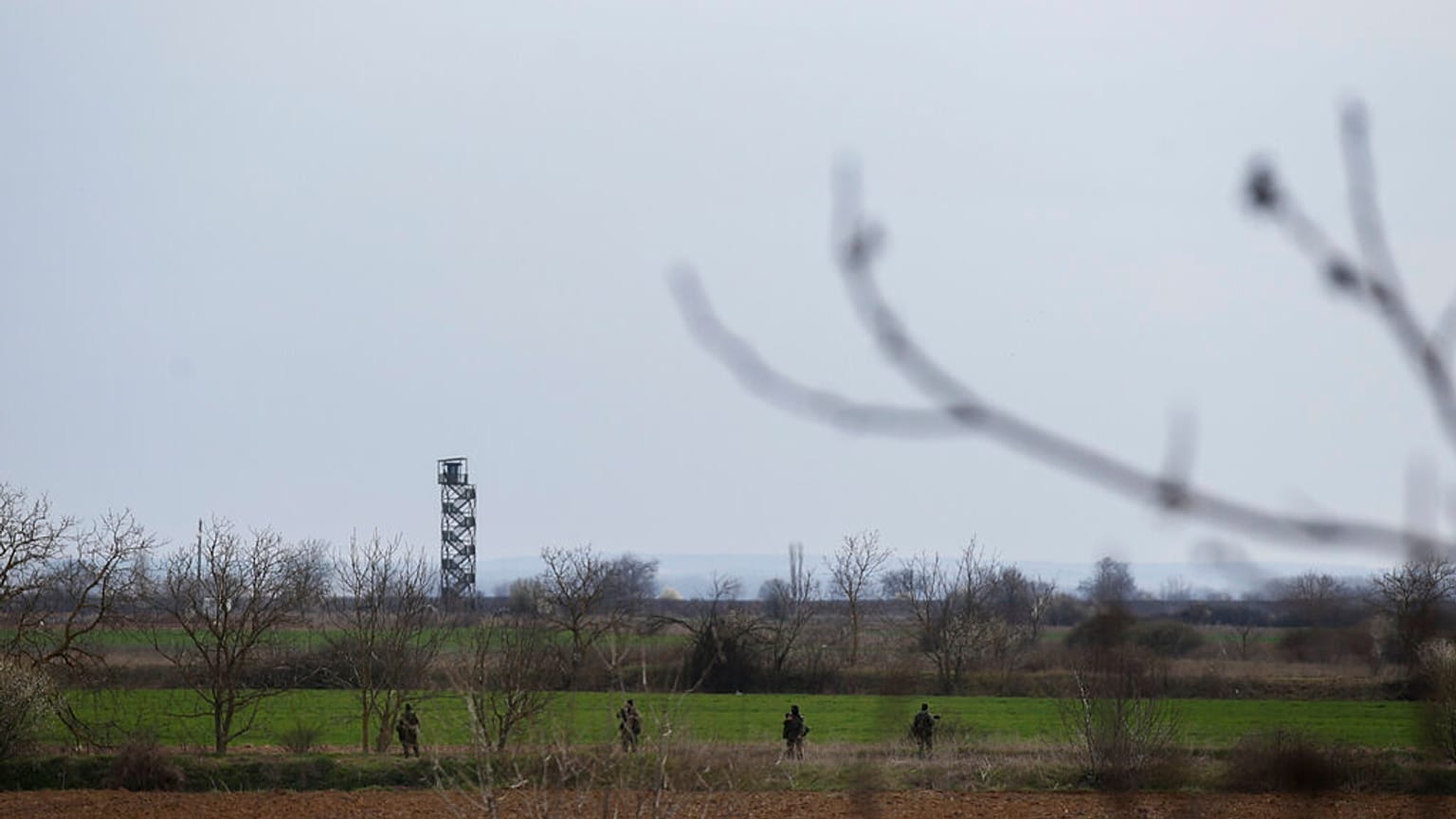 Greek Army soldiers patrol near the Greek-Turkish border in the village of Kastanies