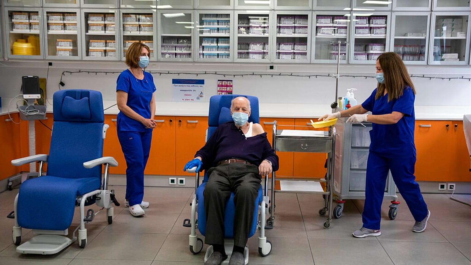 Michalis Giovanidis, a nursing home resident, waits to receive an injection with a dose of COVID-19 vaccine, in Athens