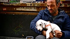 Vicente Mata, a 41-year-old homeless man, begs for money on an empty Estafeta street during lockdown to prevent the spread of coronavirus, in Pamplona, northern Spain