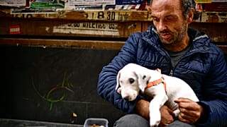 Vicente Mata, a 41-year-old homeless man, begs for money on an empty Estafeta street during lockdown to prevent the spread of coronavirus, in Pamplona, northern Spain
