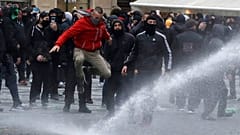 Water canon is used against demonstrators as they gather to protest against the COVID-19 restrictive measures at Old Town Square in Prague, Czech Republic