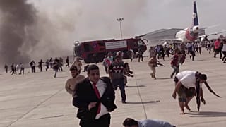 People run following an explosion at the airport in Aden, Yemen, shortly after a plane carrying the newly formed Cabinet landed on Wednesday, Dec. 30, 2020.