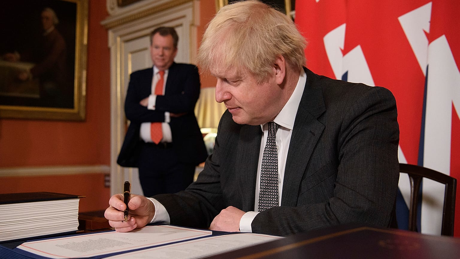 Boris Johnson signs the EU-UK Trade and Cooperation Agreement at 10 Downing Street, London Wednesday Dec. 30, 2020.