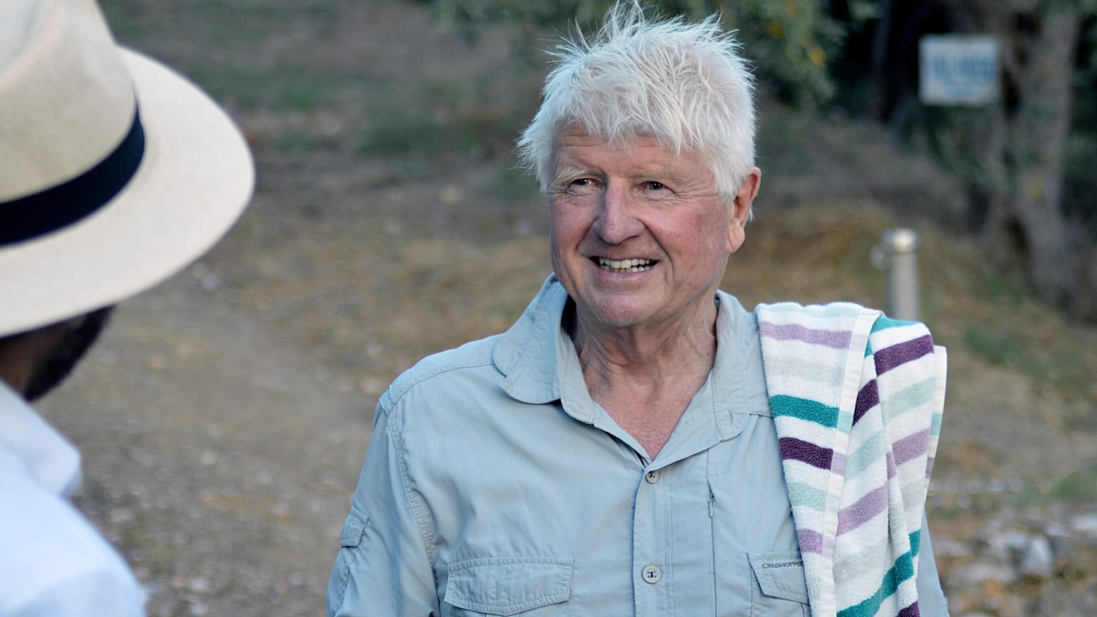 Stanley Johnson, father of Britain's Prime Minister Boris Johnson, speaks with a local reporter, outside his Villa Irene in Horto village, Mount Pelion
