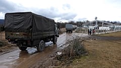 Bosnian soldiers arrive at the Lipa refugee camp outside Bihac, to erect tents for some hundreds of migrants who have been stuck in a burnt out camp.